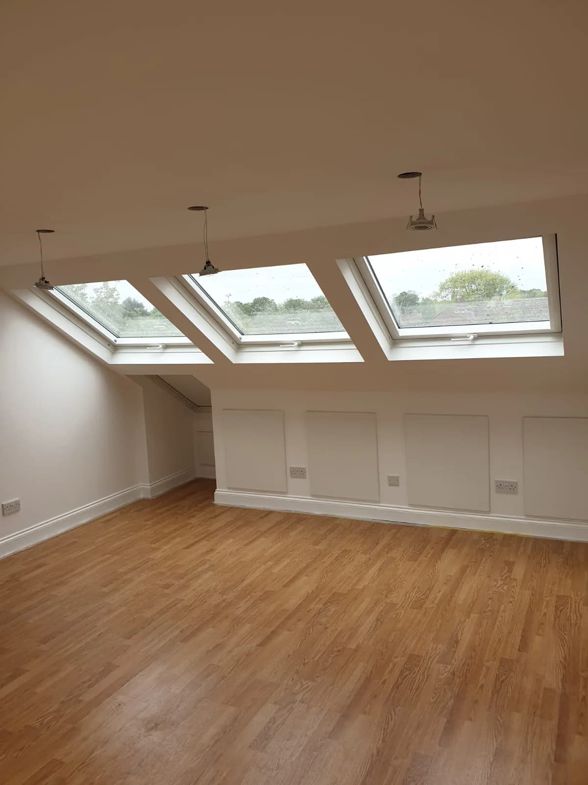 Bright decorated interior with rooflights and timber floor